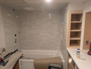 Renovated bathroom featuring double vanity and walk-in shower